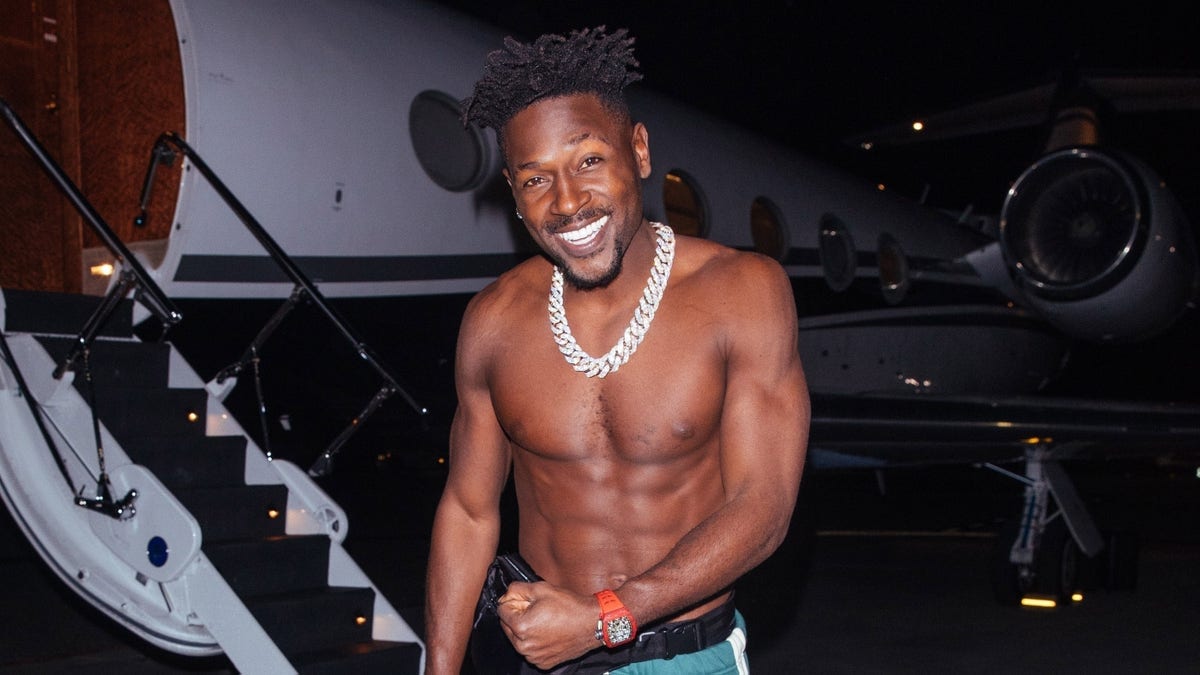 A shirtless Antonio Brown steps off his private jet to meet with Kanye West &amp;amp; Rich Owner of Fashionova at Craig's in West Hollywood.