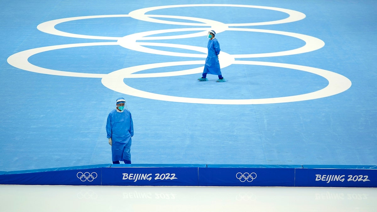 Medical personnel stand ready for activity during a scheduled speedskating practice session inside at the National Speed Skating Oval the 2022 Winter Olympics, Thursday, Jan. 27, 2022, in Beijing.