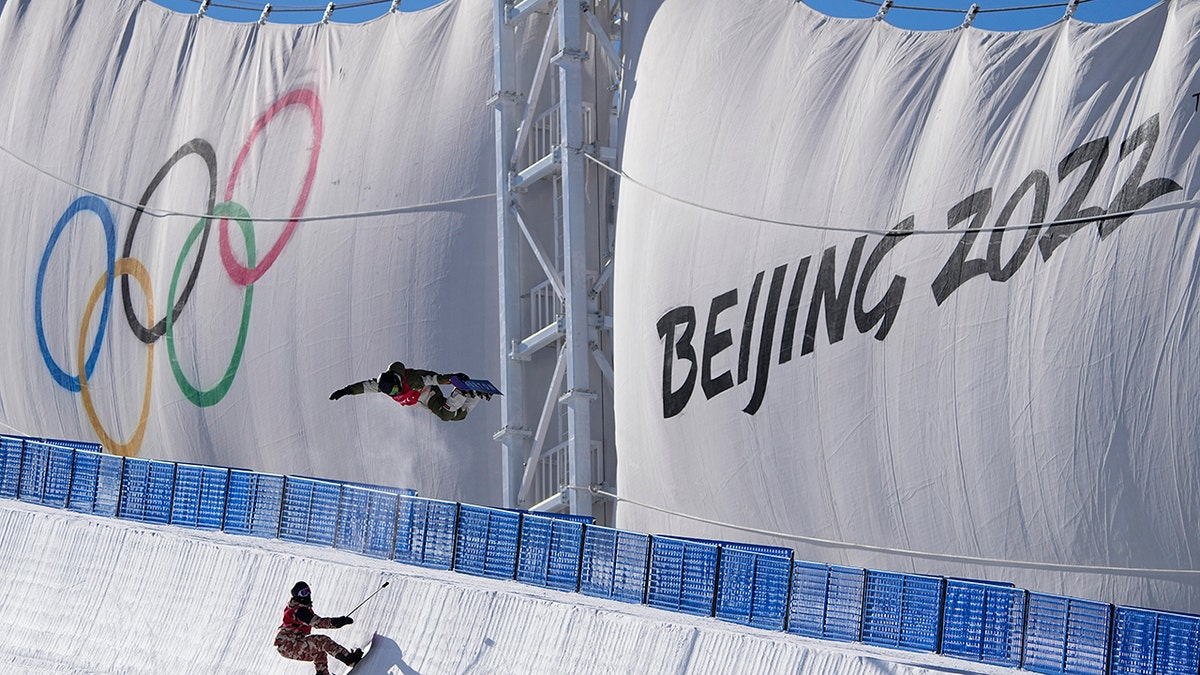 A snowboarder catches air while training on the half pipe ahead of the 2022 Winter Olympics, Thursday, Jan. 27, 2022, in Zhangjiakou, China.