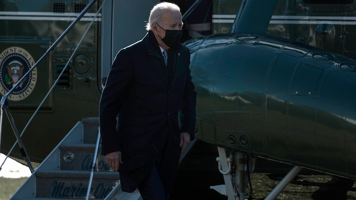 President Biden walks across the South Lawn after returning to the White House on Marine One on Jan. 10, 2022, in Washington, D.C. 