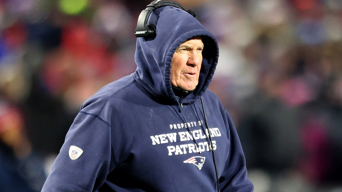 Head coach Bill Belichick of the New England Patriots walks on the field during an injury timeout during the fourth quarter against the Buffalo Bills at Highmark Stadium on Dec. 6, 2021, in Orchard Park, New York.