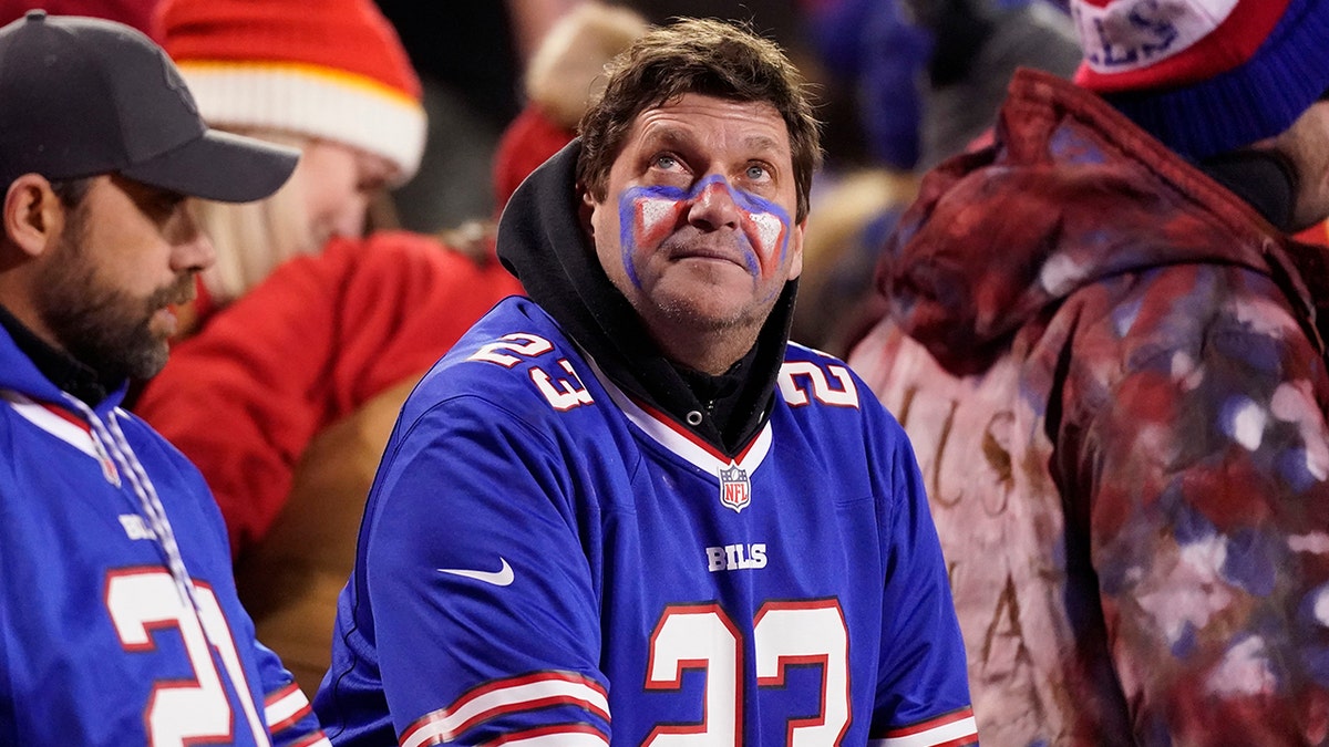 Fans watch from the stands during overtime in an NFL divisional-round playoff football game between the Kansas City Chiefs and the Buffalo Bills, Sunday, Jan. 23, 2022, in Kansas City, Missouri. 