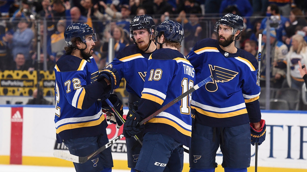 St. Louis Blues left wing Pavel Buchnevich, second from left, is congratulated after his goal against the Washington Capitals during the third period of an NHL hockey game Friday, Jan. 7, 2022, in St. Louis. 