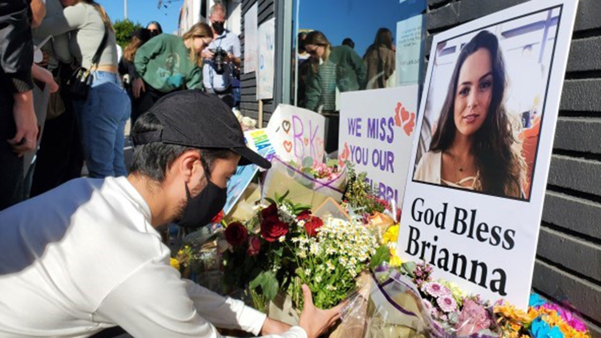 Mourners gathered Thursday in front of the Los Angeles furniture shop to remember Brianna Kupfer, who was stabbed to death inside the store.