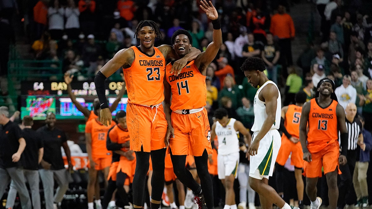 Jan 15, 2022; Waco, Texas, USA; Oklahoma State Cowboys guard Bryce Williams (14) celebrates with forward Tyreek Smith (23) following their victory over the Baylor Bears at Ferrell Center.