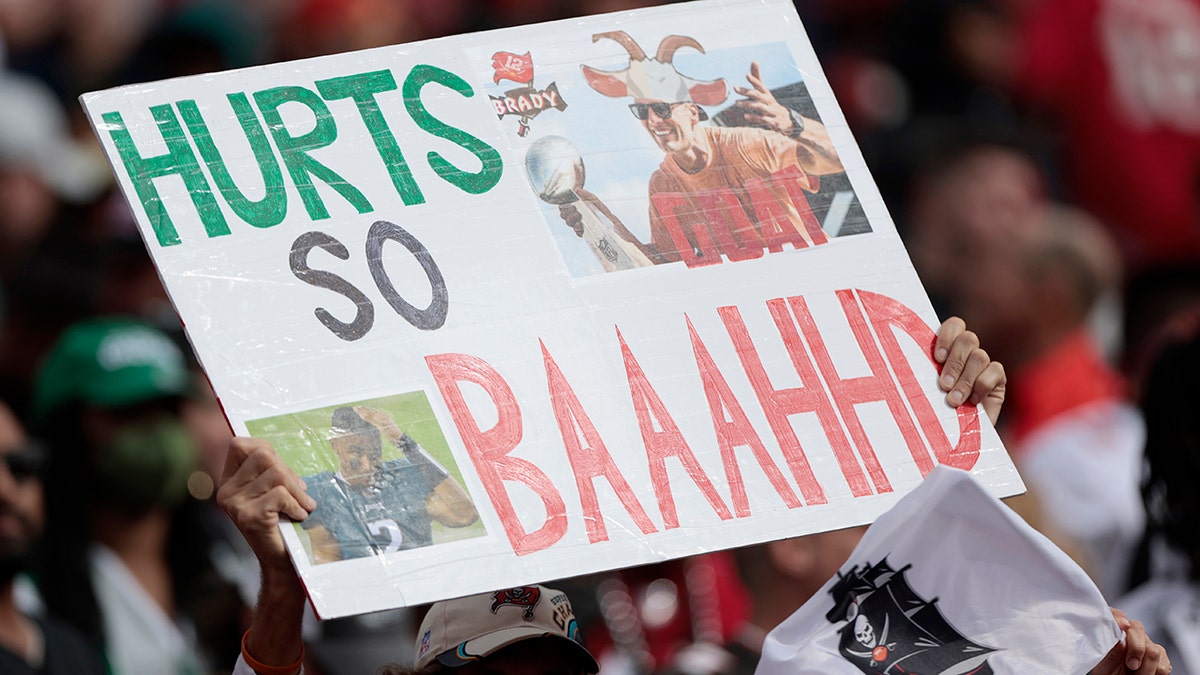 A fan holds a sign that reads, "Hurts So Baaahhd." during the NFC Wild Card Playoff game between the Philadelphia Eagles and the Tampa Bay Buccaneers at Raymond James Stadium on January 16, 2022 in Tampa, Florida.