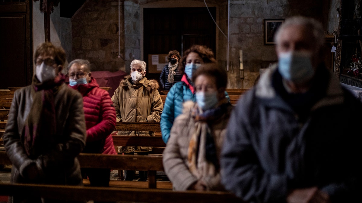 Parishioners pray at the Saturday Mass at the Catholic church of Cazurra, a village of around 75 inhabitants, in the Zamora province of Spain, Saturday, Nov. 27, 2021. Zamora has 304 parishes and only about 130 priests serving them.