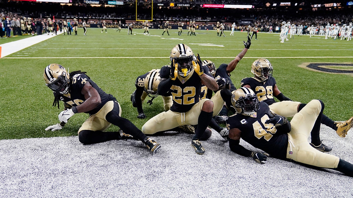 New Orleans Saints defensive back Chauncey Gardner-Johnson (22) celebrates his interception with teammates in the second half of an NFL football game against the Carolina Panthers in New Orleans, Sunday, Jan. 2, 2022. 