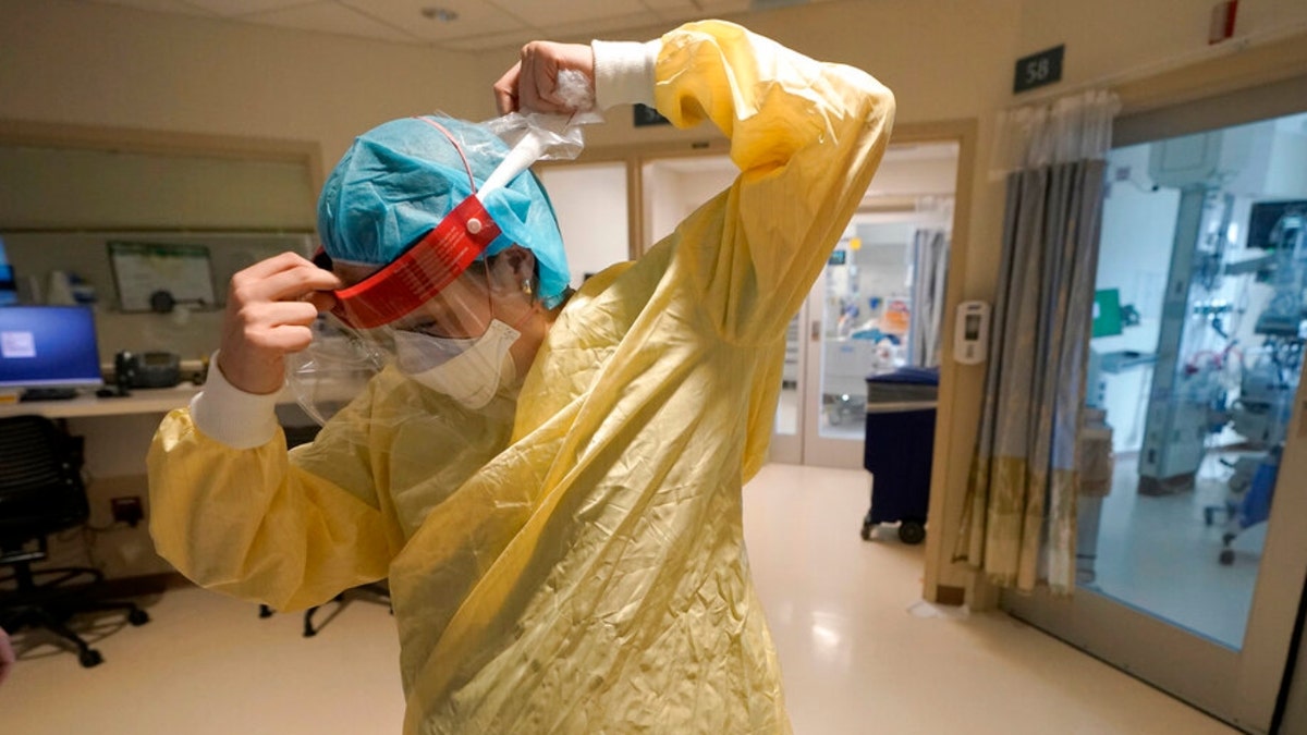 Registered nurse Sara Nystrom, of Townshend, Vt., prepares to enter a patient's room in the COVID-19 Intensive Care Unit at Dartmouth-Hitchcock Medical Center, in Lebanon, New Hampshire, Jan. 3, 2022.?