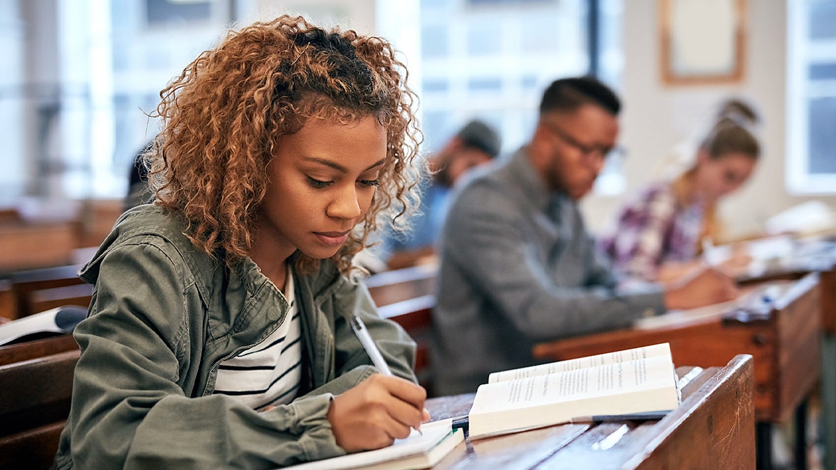 Cropped shot of university students sitting in class