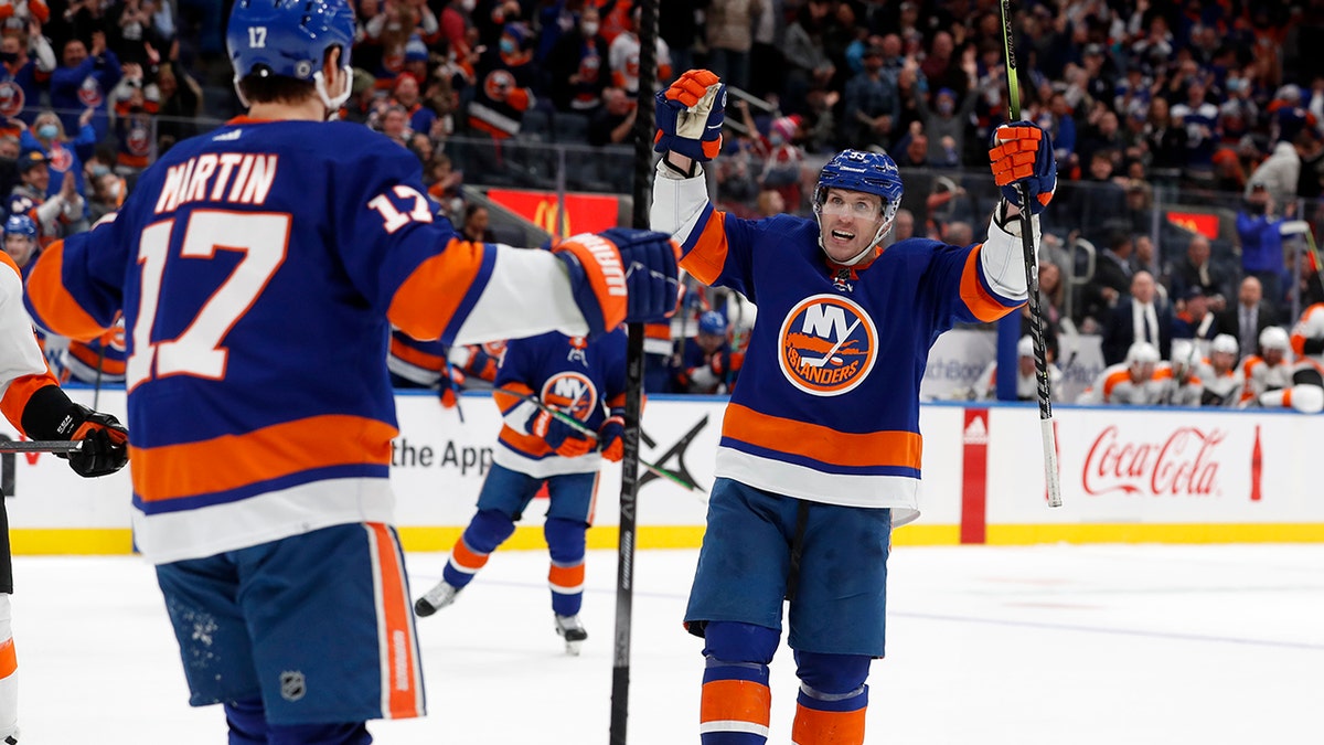 New York Islanders center Casey Cizikas (53) celebrates after his goal in the second period of an NHL hockey game against the Philadelphia Flyers with teammate left wing Matt Martin (17) on Monday, Jan. 17, 2022, in Elmont, N.Y.
