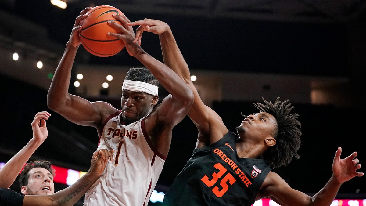Southern California forward Chevez Goodwin, left, grabs a rebound away from Oregon State forward Glenn Taylor Jr. during the second half of an NCAA college basketball game Thursday, Jan. 13, 2022, in Los Angeles.