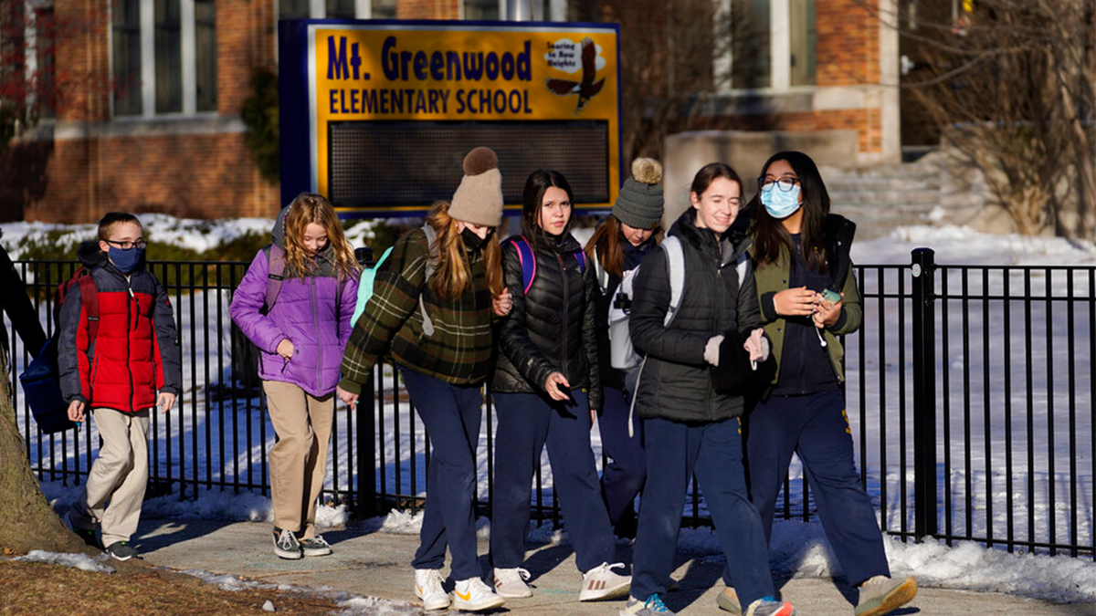 Students at the Mt. Greenwood Elementary School in Chicago depart after a full day of classes Monday, Jan. 10, 2022.