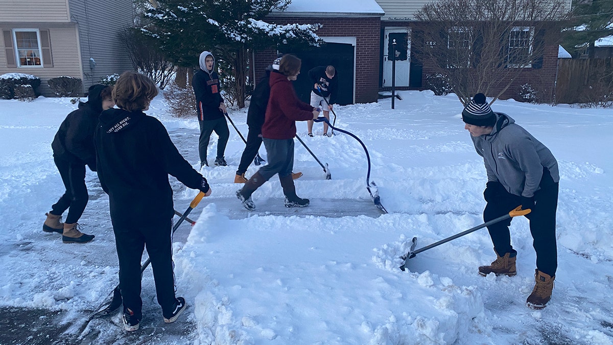 The football players didn’t just shovel driveways on Monday. They also shoveled more driveways together on Tuesday. 