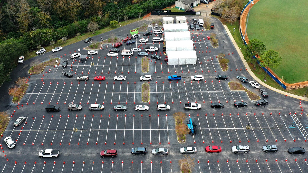 Cars line up at a COVID-19 testing site at the South Orange Youth Sports Complex in Orlando, Florida. 