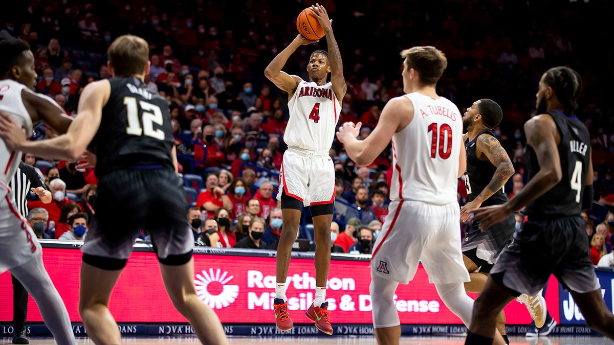 Arizona guard Dalen Terry (4) shoots a three-point basket against Washington during the first half of an NCAA college basketball game in Tucson, Ariz., Monday, Jan. 3, 2022. 