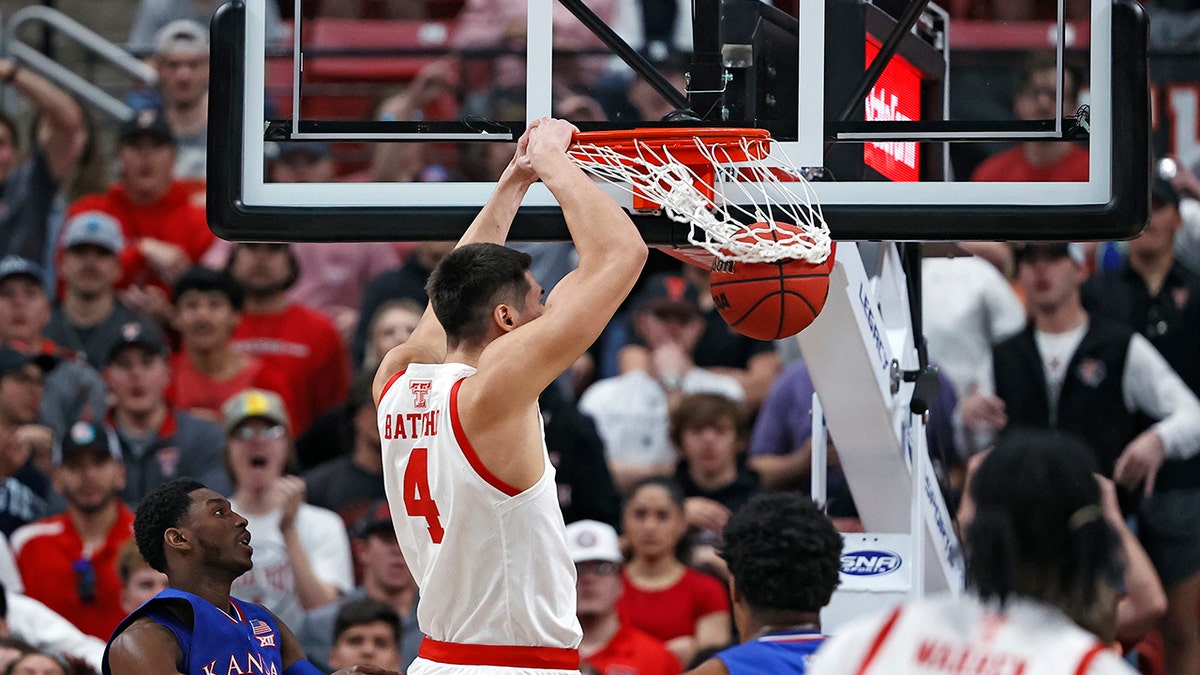 Texas Tech's Daniel Batcho (4) dunks the ball during the first half of an NCAA college basketball game against Kansas, Saturday, Jan. 8, 2022, in Lubbock, Texas. 