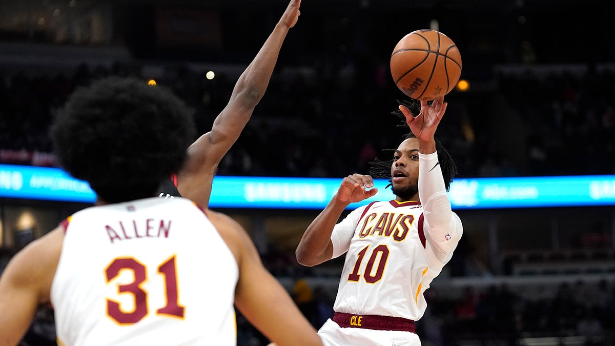 Cleveland Cavaliers' Darius Garland (10) passes to Jarrett Allen during the first half of the team's NBA basketball game against the Chicago Bulls on Wednesday, Jan. 19, 2022, in Chicago.