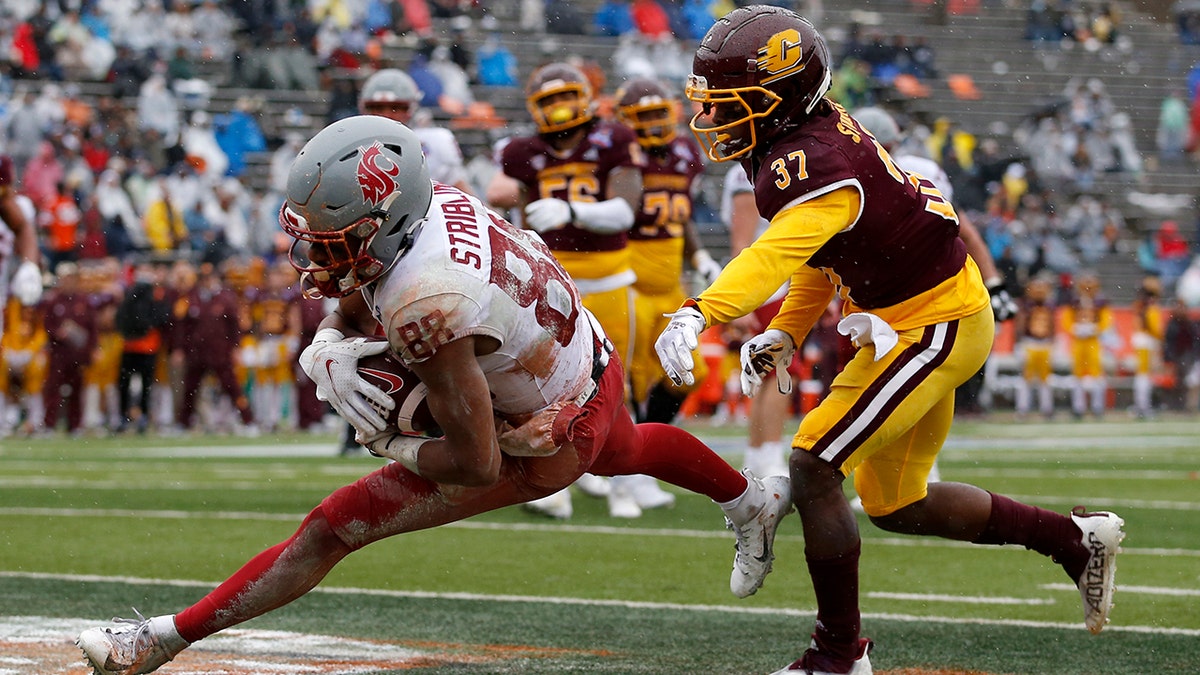Washington State wide receiver De'Zhaun Stribling (88) catches a pass in the end zone to score a touchdown as he's defended by Central Michigan defensive back Rolliann Sturkey (37) during the second half of the Sun Bowl in El Paso, Texas, Friday, Dec. 31, 2021.