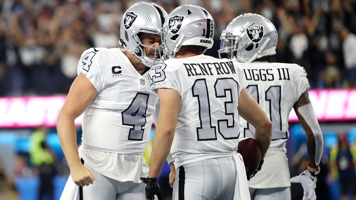 Hunter Renfrow #13 of the Los Angeles Chargers celebrates his touchdown with teammate Derek Carr #4 during the third quarter against the Los Angeles Chargers at SoFi Stadium on October 04, 2021 in Inglewood, California.