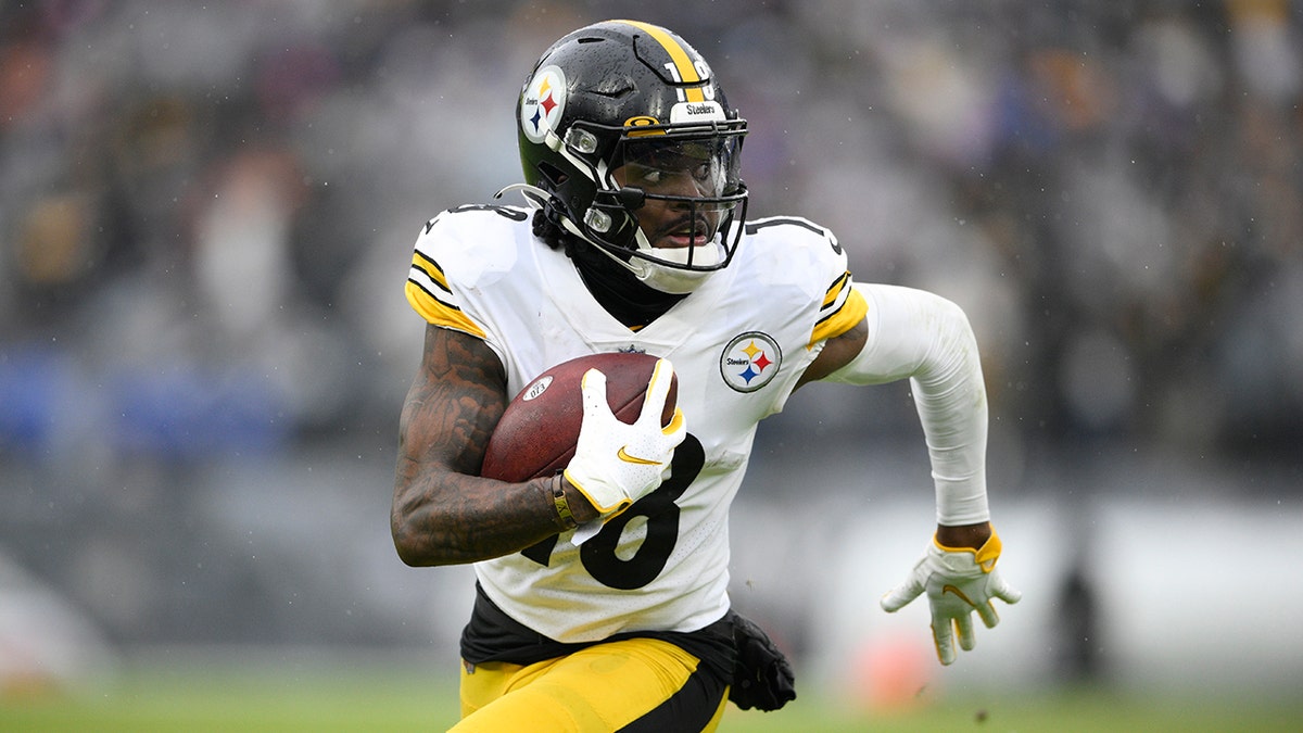 Pittsburgh Steelers wide receiver Diontae Johnson runs with the ball after making a catch against the Baltimore Ravens during the second half of an NFL football game, Sunday, Jan. 9, 2022, in Baltimore.