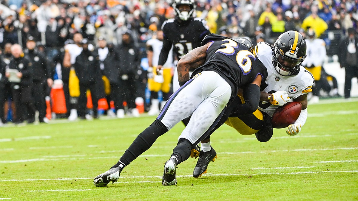 Baltimore Ravens safety Chuck Clark (36) tackles Pittsburgh Steelers wide receiver Diontae Johnson (18) during the first quarter at M&T Bank Stadium Jan. 9, 2022, in Baltimore.