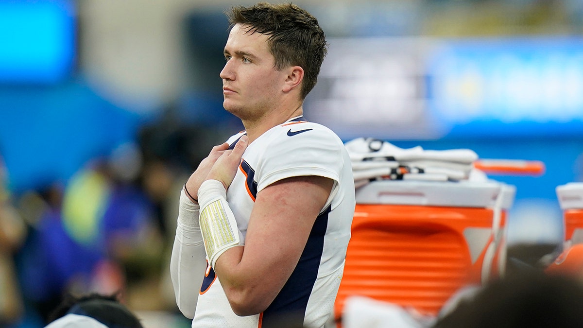 Denver Broncos quarterback Drew Lock stands on the bench in the closing minutes of a loss to the Los Angeles Chargers during an NFL football game Sunday, Jan. 2, 2022, in Inglewood, Calif. 
