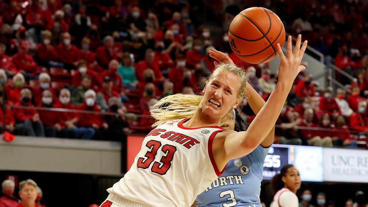 North Carolina State's Elissa Cunane (33) grabs a rebound in front of North Carolina's Kennedy Todd-Williams (3) during the first half of an NCAA college basketball game, Thursday, Jan. 6, 2022, in Raleigh, N.C.