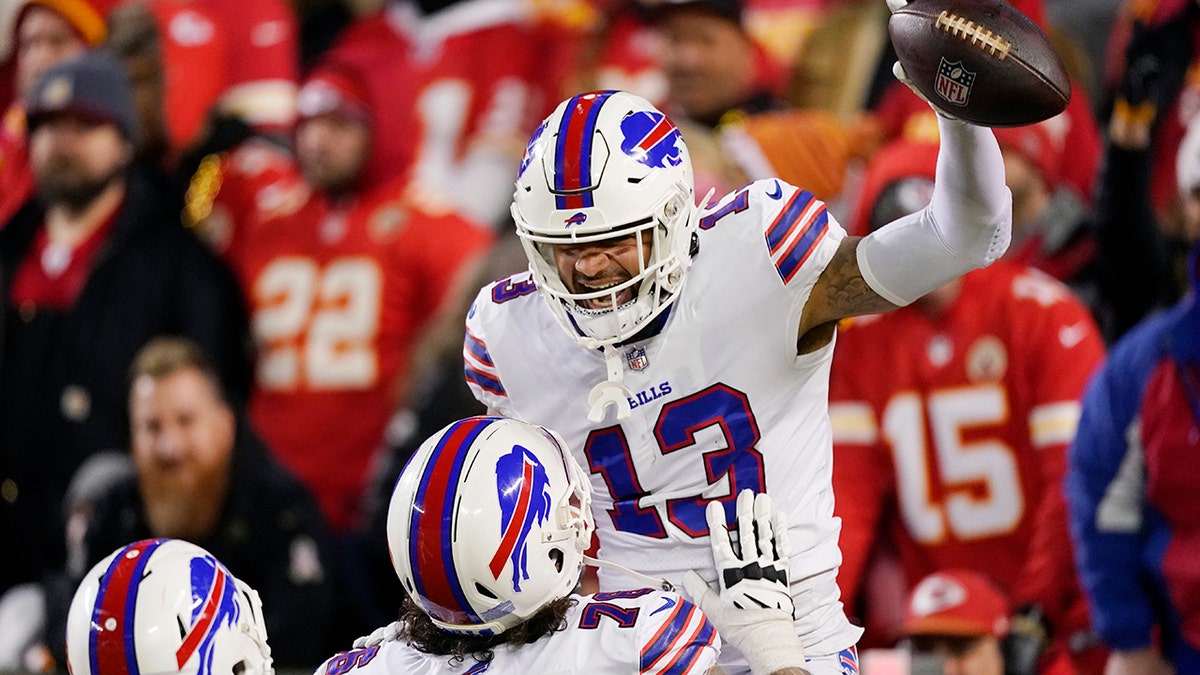 Buffalo Bills wide receiver Gabriel Davis (13) celebrates with teammate Jon Feliciano after catching a 75-yard touchdown pass during the second half of an NFL divisional round playoff football game against the Kansas City Chiefs, Sunday, Jan. 23, 2022, in Kansas City, Mo.