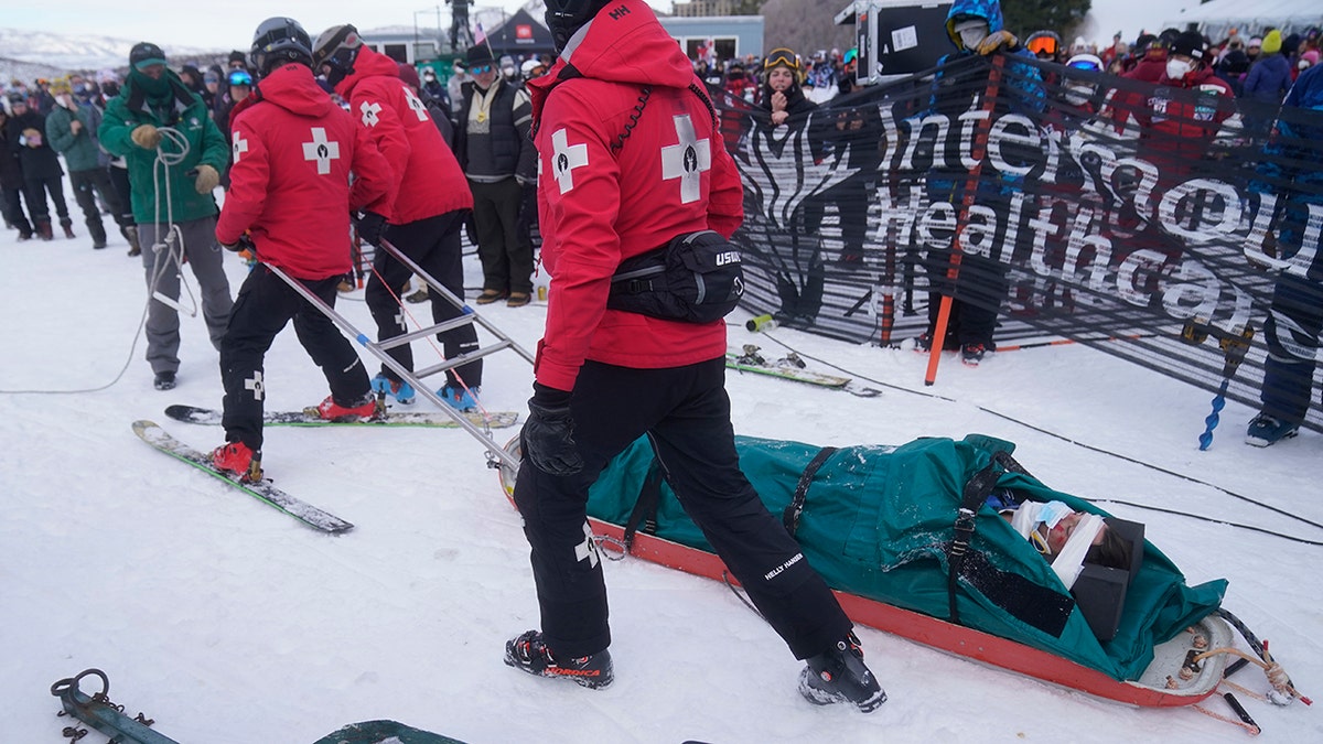 Medical officials take United States' George McQuinn off the course after he crashed at the end of a run in the finals of a World Cup freestyle moguls competition at Deer Valley Resort in Park City, Utah, Thursday, Jan. 13, 2022.