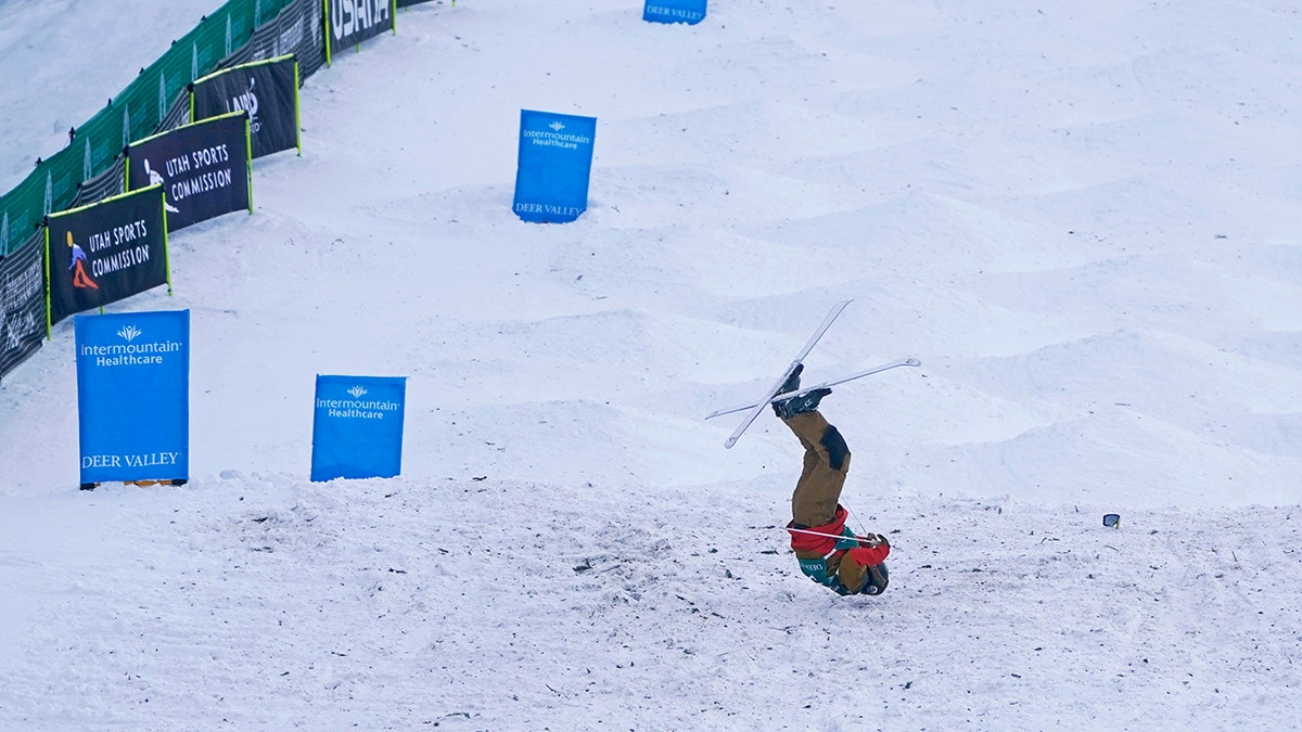 United States' George McQuinn crashes at the end of a run in the finals of a World Cup freestyle moguls competition at Deer Valley Resort in Park City, Utah, Thursday, Jan. 13, 2022.