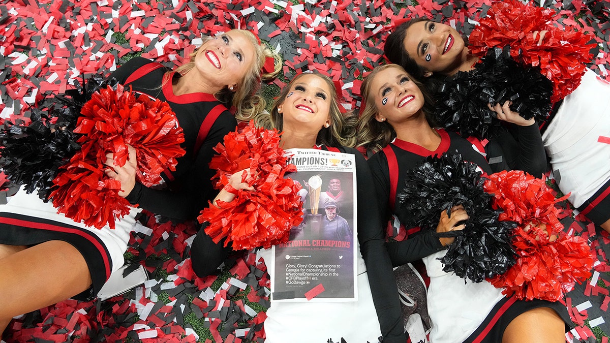 Jan 10, 2022; Indianapolis, IN, USA; Georgia Bulldogs cheerleaders celebrate on a confetti covered field after defeating the Alabama Crimson Tide in the 2022 CFP college football national championship game at Lucas Oil Stadium. 