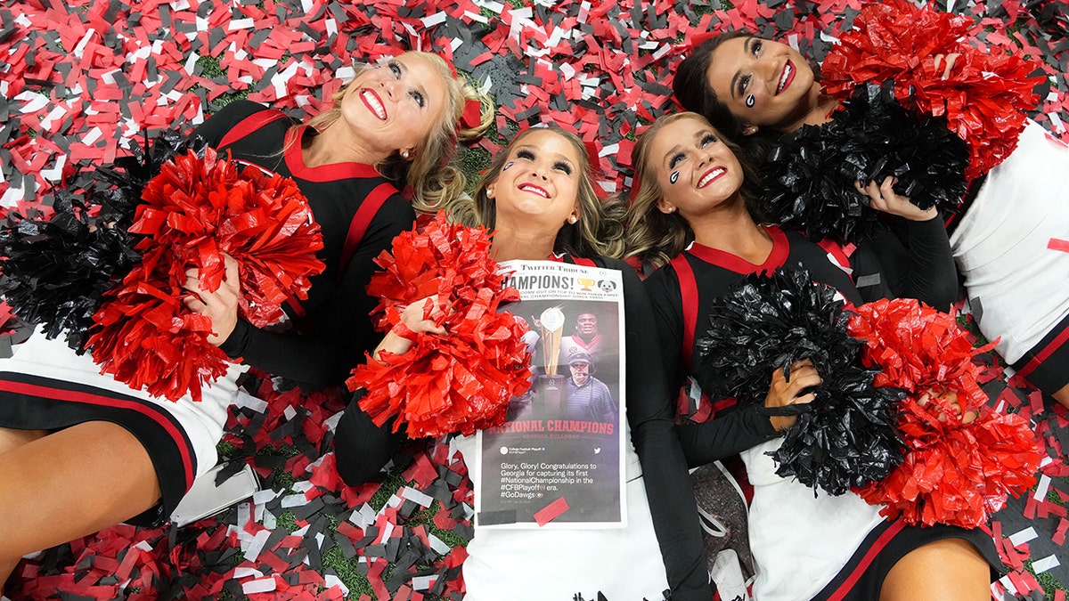 Jan 10, 2022; Indianapolis, IN, USA; Georgia Bulldogs cheerleaders celebrate on a confetti covered field after defeating the Alabama Crimson Tide in the 2022 CFP college football national championship game at Lucas Oil Stadium.