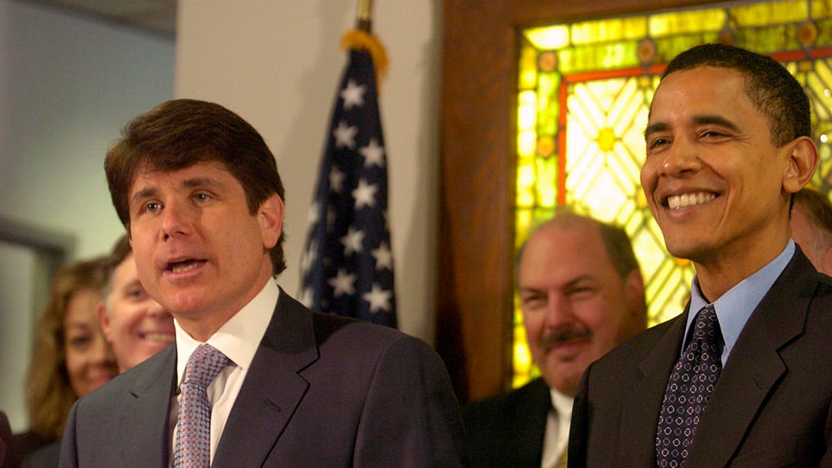 In this April 2, 2004 file photograph, state Senator Barack Obama and other Illinois elected officials joined Gov. Rod Blagojevich as he signed a bill into law at the Thompson Center in downtown Chicago. (Photo by Milbert O. Brown/Chicago Tribune/Tribune News Service via Getty Images)