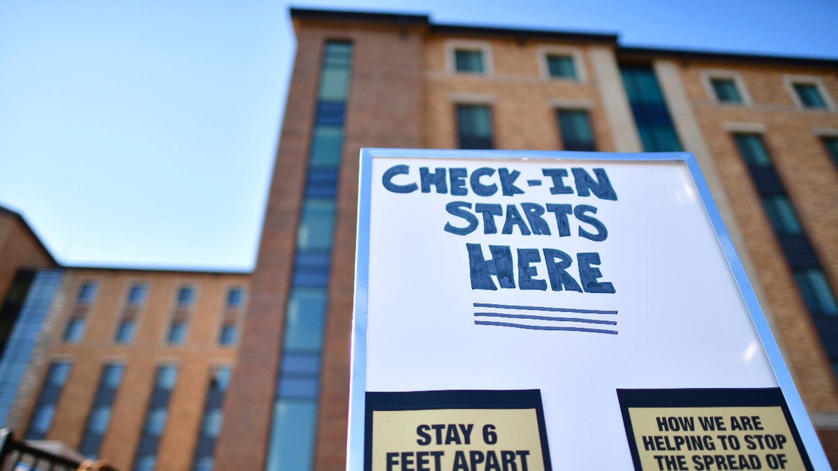 Placards advise physical distancing guidelines due to the coronavirus pandemic while directing incoming freshman moving into a campus dormitory at University of Colorado Boulder on August 18, 2020 in Boulder, Colorado. (Photo by Mark Makela/Getty Images)