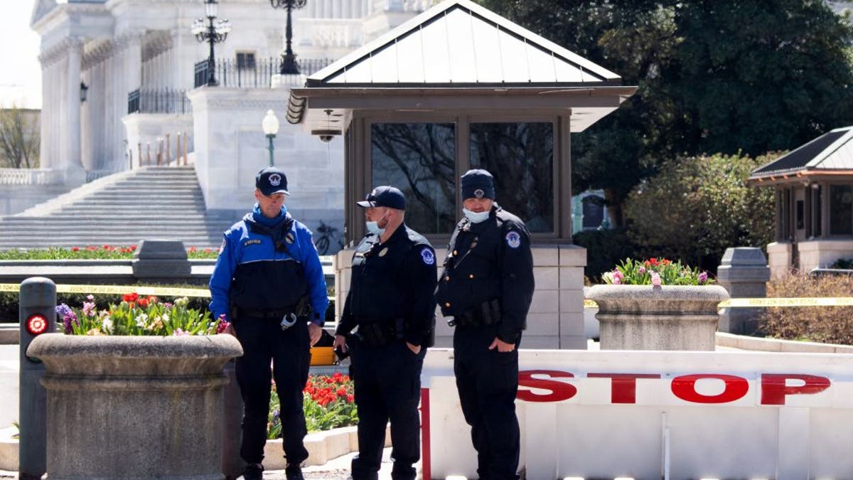 Members of the US Capitol Police, on April 3, 2021, pause to pay their respects at the US Capitol location where fellow officer, William Evans, was killed in an attack, in Washington, D.C. (Photo by SAUL LOEB / AFP)
