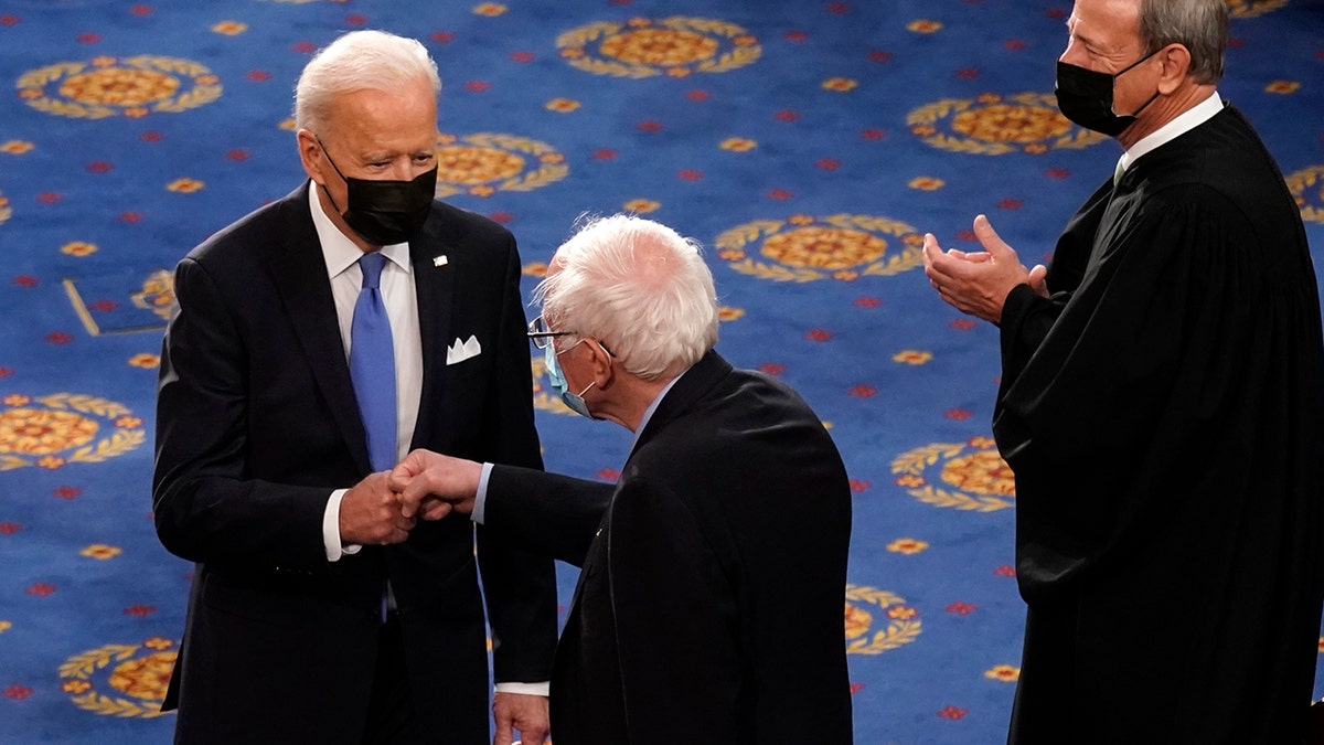 President Biden greets Sen. Bernie Sanders