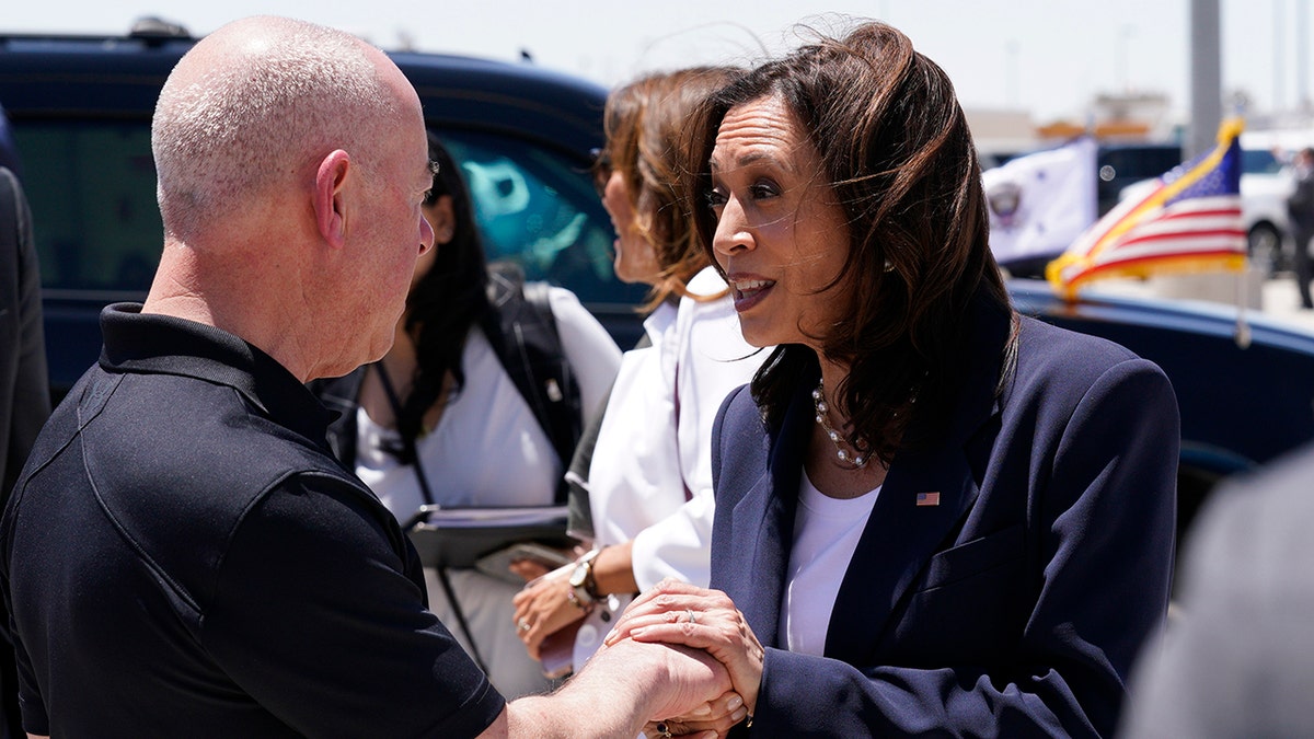 U.S. Vice President Kamala Harris speaks with Alejandro Mayorkas, secretary of the U.S. Department of Homeland Security, before boarding Air Force Two at the El Paso International Airport in El Paso, Texas.