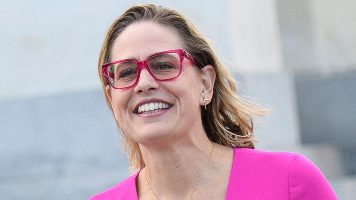 Kyrsten Sinema wearing pink glasses at US capitol in Washington