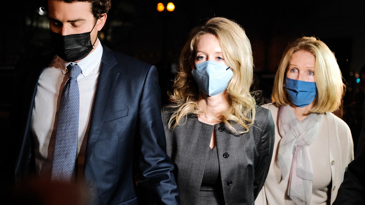 Theranos founder and former CEO Elizabeth Holmes, center, walks with her partner Billy Evans and her mother Noel Holmes as they leave the Robert F. Peckham Federal Building on Jan. 3, 2022 in San Jose, California. (David Odisho/Getty Images)