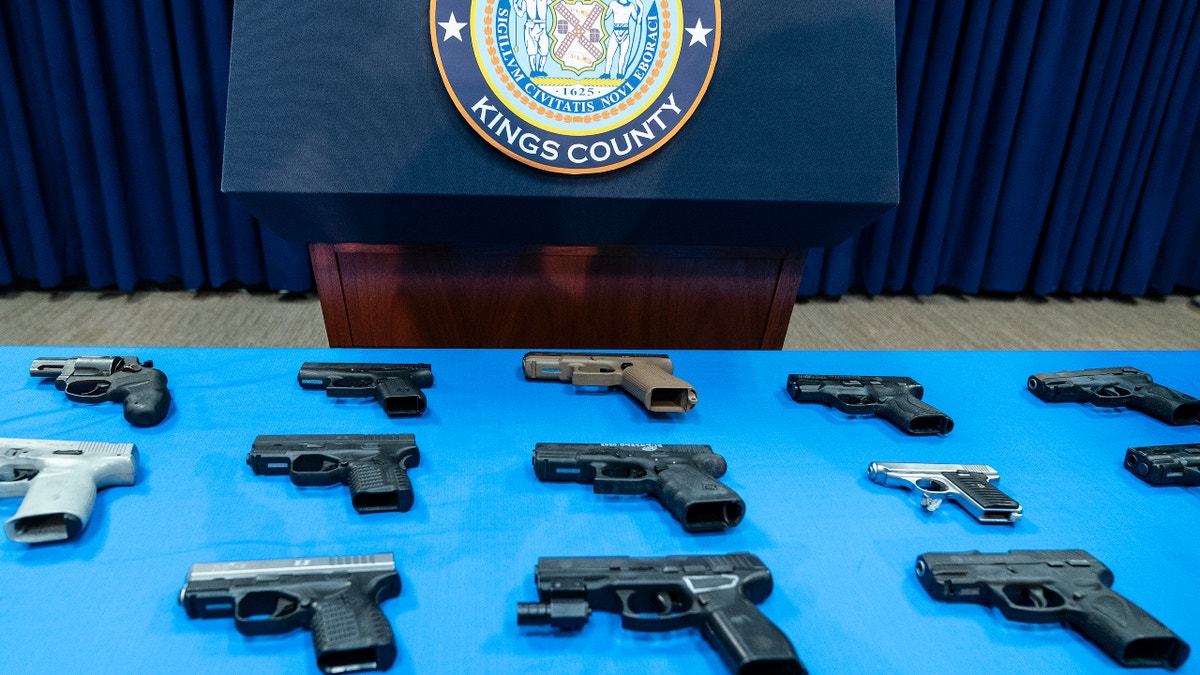 NEW YORK, UNITED STATES - 2022/01/04: Guns confiscated from gang members on display during Brooklyn District Attorney Eric Gonzalez press conference in District Attorney office. Gonzalez announced indictment of 17 gang members of murders and gun violence across Brooklyn. 20 guns owned by those gang members were on display during the presser. Out of 17 indicted people 14 were already in custody at the time of the press conference. (Photo by Lev Radin/Pacific Press/LightRocket via Getty Images)