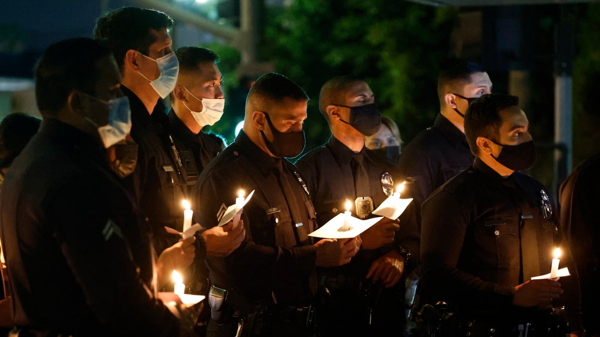 Los Angeles Police Officers attend a candlelight vigil for their fallen LAPD Officer Fernando Arroyos