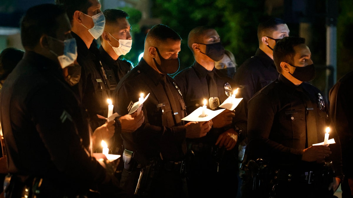 Los Angeles Police Officers attend a candlelight vigil for their fallen LAPD Officer Fernando Arroyos