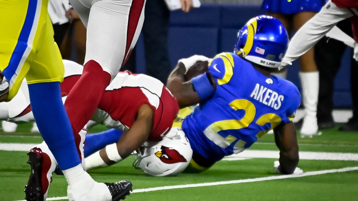 Cardinals Budda Baker, #3, suffered an injury as his head was tucked under Rams Cam Akers, #23, during fourth quarter action in the NFC Wild Card game at SoFi Stadium Monday, January 17. 2022. The Rams defeated the Cardinals 34-11.   