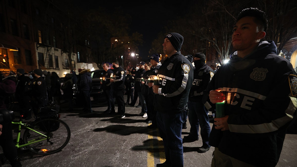 Hundreds of New York City police officers and firefighters gather Saturday at the 32nd Precinct in Harlem for a vigil honoring two officers who were shot in Harlem on Friday night. One police officer died, the other was critically wounded. 