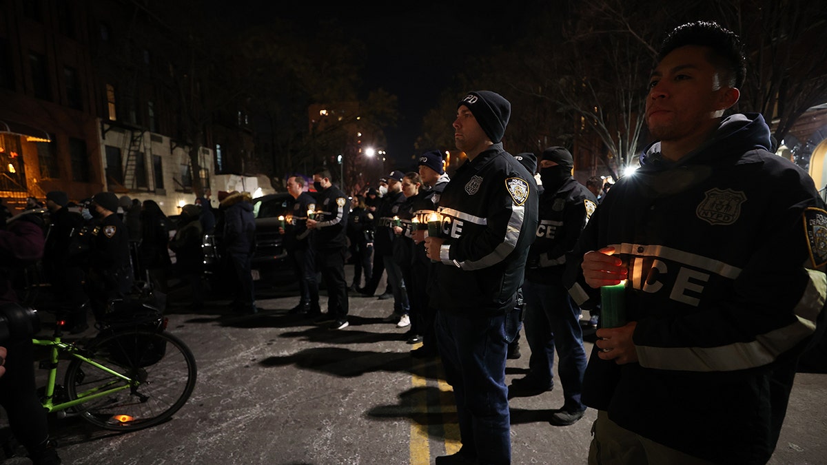 Hundreds of New York City police officers and firefighters gather Saturday at the 32nd Precinct in Harlem for a vigil honoring two officers who were shot in Harlem on Friday night. One police officer died, the other was critically wounded.