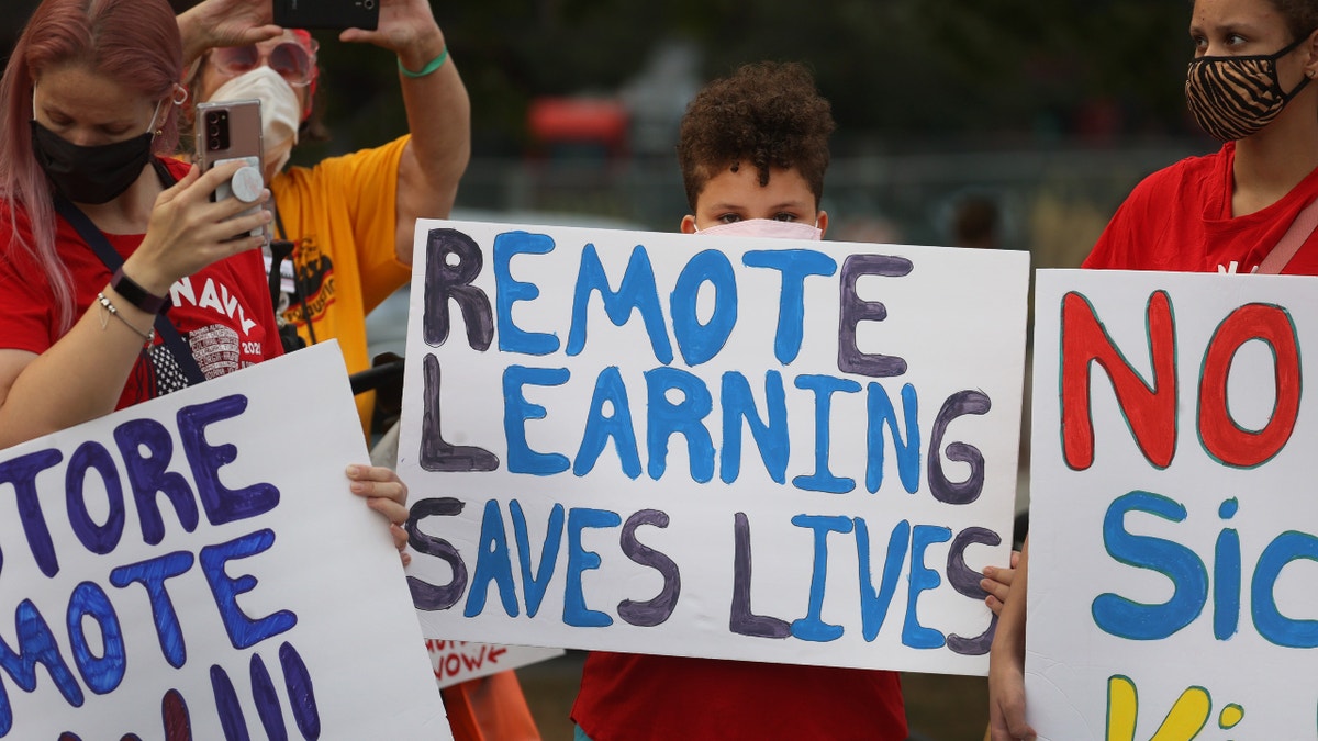 Chicago Public School teachers, parents and students protest in the neighborhood of Mayor Lori Lightfoot on September 13, 2021 in Chicago, Illinois. The group called on the mayor and school district to, among other things, offer a remote-learning option for students too young to be vaccinated against the Covid-19 virus. (Photo by Scott Olson/Getty Images)