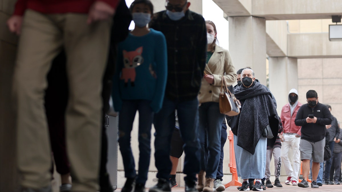 People wait in line to be tested for COVID-19 at Union Station