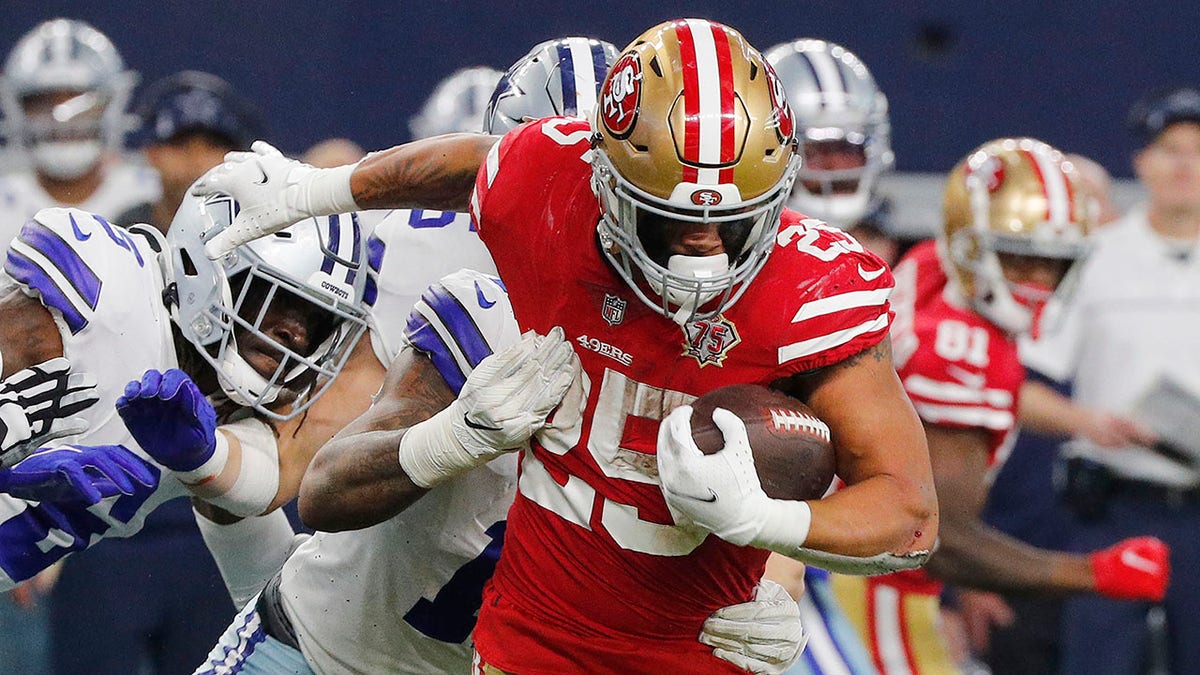 Elijah Mitchell #25 of the San Francisco 49ers carries the ball against the Dallas Cowboys during the second quarter in the NFC Wild Card Playoff game at AT&amp;T Stadium on January 16, 2022 in Arlington, Texas.