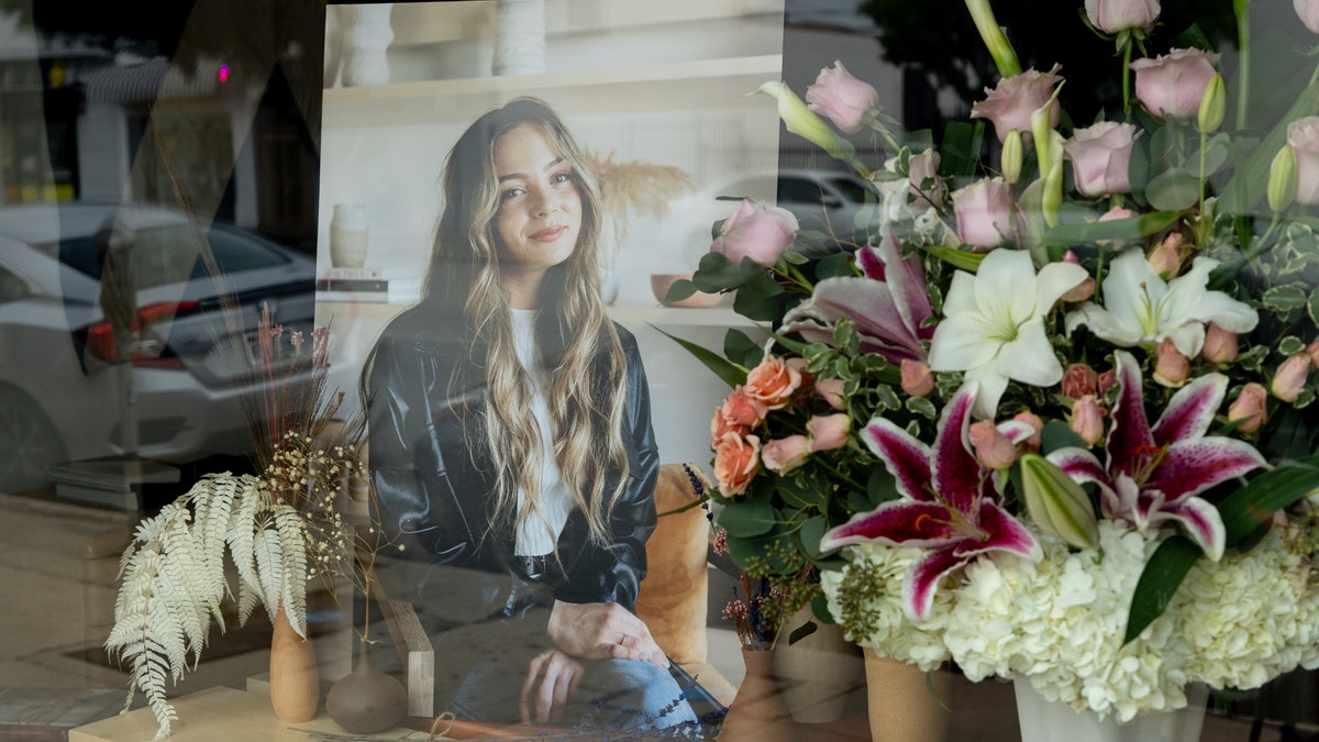 Flowers are placed outside Croft House furniture store in memory of graduate student Brianna Kupfer. 